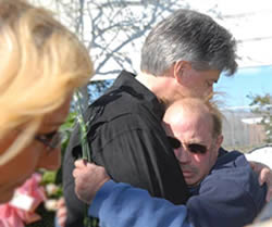 Mark Steinway comforts John Bozes during the memorial ceremony held in front of P.G.T. Beauregard Middle School in St. Bernard, LA. The school was the sight of 33 pets allegedly slaughtered by St. Bernard Sheriffs in the days following Katrina.