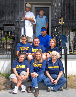 © 2008 Photo by Laura Richard Feeders and rescuers with the Johnsons on their front porch in the Upper Ninth Ward of New Orleans. All met one Sunday afternoon to celebrate the homecoming of Samantha, the cat who waited so long for her caretakers to come home. Four of the feeders pictured come every other week from Baton Rouge, about 90 miles away, to make sure stations are full of food and available to the pets left homeless since Katrina.